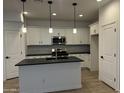 Modern kitchen featuring white cabinets and a large island at 1223 W Sparrow Dr, Queen Creek, AZ 85140