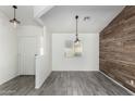 Bright dining room with wood-look accent wall and gray tile floor at 12962 W Catalina Dr, Avondale, AZ 85392