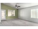 Spacious living room with neutral wall color, carpet flooring, and a ceiling fan at 12962 W Catalina Dr, Avondale, AZ 85392