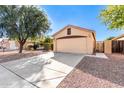 Single-story house with a two-car garage and desert landscaping at 13353 W Port Royale Ln, Surprise, AZ 85379