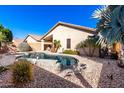 Inviting backyard oasis featuring a sparkling pool and relaxing patio at 13353 W Port Royale Ln, Surprise, AZ 85379