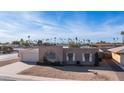 Single story home with a large backyard and palm trees at 14202 N Lakeforest Dr, Sun City, AZ 85351