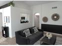 Living room with dark-grey couch and kitchen view at 1435 S Spartan St, Gilbert, AZ 85233