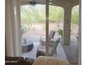 Covered patio with comfortable seating and views of the desert landscape at 16464 W Piccadilly Rd, Goodyear, AZ 85395