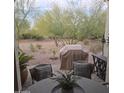 Outdoor patio with seating, grill, and desert landscape views at 16464 W Piccadilly Rd, Goodyear, AZ 85395