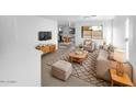 Bright living room with mid-century modern furniture and tile floors at 1708 E Galveston St, Gilbert, AZ 85295