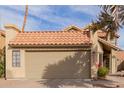 Two-story house with tan exterior, brown tile roof, and attached garage at 1740 W Del Rio St, Chandler, AZ 85224