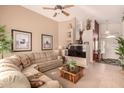 Spacious living room featuring a large sectional sofa and a flat-screen TV at 18109 W Skyline Dr, Surprise, AZ 85374