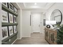 Bright and spacious entryway with wood-look floors and built-in shelving at 19027 W Rose Ln, Waddell, AZ 85355