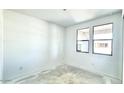 Bright bedroom with new flooring and large windows at 22859 E Lords Way, Queen Creek, AZ 85142