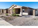 Two-story house with a two-car garage and stone accents, nicely landscaped at 24 S 175Th Ave, Goodyear, AZ 85338