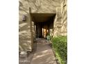 Inviting entryway with a wooden door and lush landscaping at 28414 N 101St Pl, Scottsdale, AZ 85262