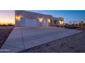 Large concrete driveway leading to a beautiful three-car garage home at 29456 N 208Th Ln, Wittmann, AZ 85361