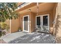 Front entrance with a bench, potted plant, and double doors at 3511 E Baseline Rd # 1243, Phoenix, AZ 85042