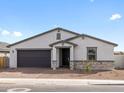 Front exterior view of a one-story home showcasing a two-car garage, neutral paint scheme, and landscaping at 35581 N Thicket Way, San Tan Valley, AZ 85144