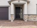 Close-up of the entryway with a covered porch and brick accents, enhancing the home's curb appeal at 35581 N Thicket Way, San Tan Valley, AZ 85144