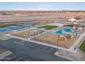 Aerial view of a community featuring playground, pickleball courts, and open space at 36999 W Prado St, Maricopa, AZ 85138