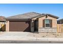 Attractive single-story house boasting a two-car garage, stone veneer, and a low-maintenance front yard at 37042 W Prado St, Maricopa, AZ 85138