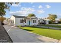 Newly renovated home with artificial turf and a long driveway at 3850 N 12Th Ave, Phoenix, AZ 85013