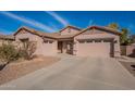 Two-story home with a large driveway and landscaping at 44562 W Sedona Trl, Maricopa, AZ 85139