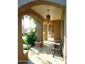 Inviting front porch with arched entryway and wrought iron bench at 522 W Roosevelt St, Phoenix, AZ 85003