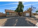 Front yard view of a single story home with a gravel driveway at 6207 W Acoma Dr, Glendale, AZ 85306