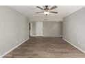 Bright living room featuring gray walls and wood-look flooring at 6207 W Acoma Dr, Glendale, AZ 85306