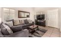 Living room with gray sectional sofa and a coffee table at 6538 W Nez Perce St, Phoenix, AZ 85043