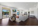 Bright living room features hardwood floors, fireplace, and access to backyard at 7687 E Wing Shadow Rd, Scottsdale, AZ 85255