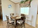 Cozy dining area with wood table and chairs, suitable for four at 7750 E Broadway Rd # 232, Mesa, AZ 85208