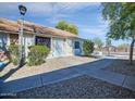 Condo entrance with walkway and well-maintained landscaping at 8901 W Loma Ln, Peoria, AZ 85345