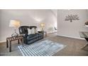 Living room features a black leather couch and end tables at 8901 W Loma Ln, Peoria, AZ 85345