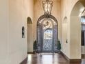 Elegant entryway with arched entry and ornate iron door at 9108 N Fireridge Trl, Fountain Hills, AZ 85268