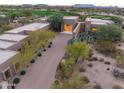 Luxury estate with a long driveway and desert landscaping at 9821 E Sundance Trl, Scottsdale, AZ 85262