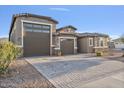 Two-story house with a three-car garage and landscaped front yard at 9925 E Orange Grove St, Florence, AZ 85132