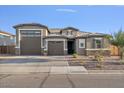 Two-story house with a three-car garage and landscaped front yard at 9925 E Orange Grove St, Florence, AZ 85132