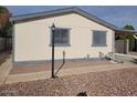 Single-wide manufactured home with a light-colored exterior and landscaped yard at 11275 N 99Th Ave # 7, Peoria, AZ 85345