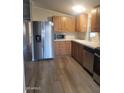 Stainless steel appliances and wood cabinets in this kitchen at 11275 N 99Th Ave # 7, Peoria, AZ 85345