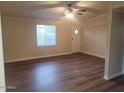 Living room with laminate flooring and ceiling fan at 11275 N 99Th Ave # 7, Peoria, AZ 85345