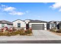 Single story home with gray garage door and drought-tolerant landscaping at 1130 W Avalon Canyon Dr, Casa Grande, AZ 85122