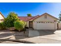 Single-story home with red tile roof, two-car garage, and citrus tree at 1201 E Campbell Ave, Gilbert, AZ 85234