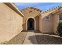 Front entry with arched doorway and stone pathway at 15158 W Camino Estrella Dr, Surprise, AZ 85374