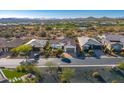 Aerial view of a luxury home community with mountain views and a lake at 17817 E Cindercone Rd, Rio Verde, AZ 85263