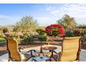 Relaxing backyard patio with fire pit and mountain views at 17817 E Cindercone Rd, Rio Verde, AZ 85263