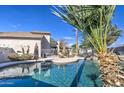 Relaxing kidney-shaped pool with palm trees and patio furniture at 20997 N 79Th Ave, Peoria, AZ 85382