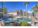 Inviting kidney-shaped pool with surrounding patio and landscaping at 20997 N 79Th Ave, Peoria, AZ 85382