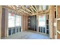 Unfinished bedroom with two windows, framing, and electrical work at 22851 E Lords Way, Queen Creek, AZ 85142