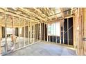 Unfinished bedroom with one window and exposed framing at 22851 E Lords Way, Queen Creek, AZ 85142