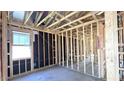 Unfinished bedroom with one window and exposed framing at 22851 E Lords Way, Queen Creek, AZ 85142