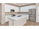 Modern kitchen with white cabinets, stainless steel appliances, and an island at 2542 W Kit Carson Trl, Phoenix, AZ 85086